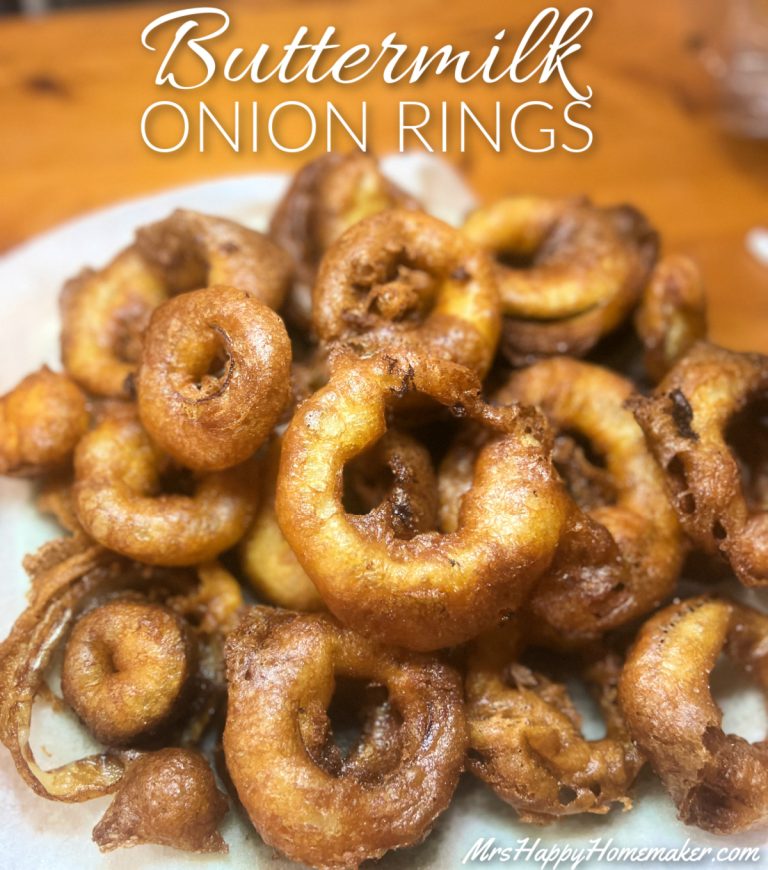 Onion rings stacked up in a pile on a paper towel